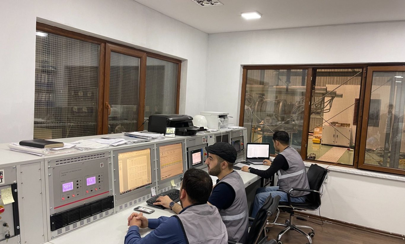 ATEF Transformer Testing ATEF technicians monitoring transformer factory tests in a testing control room.