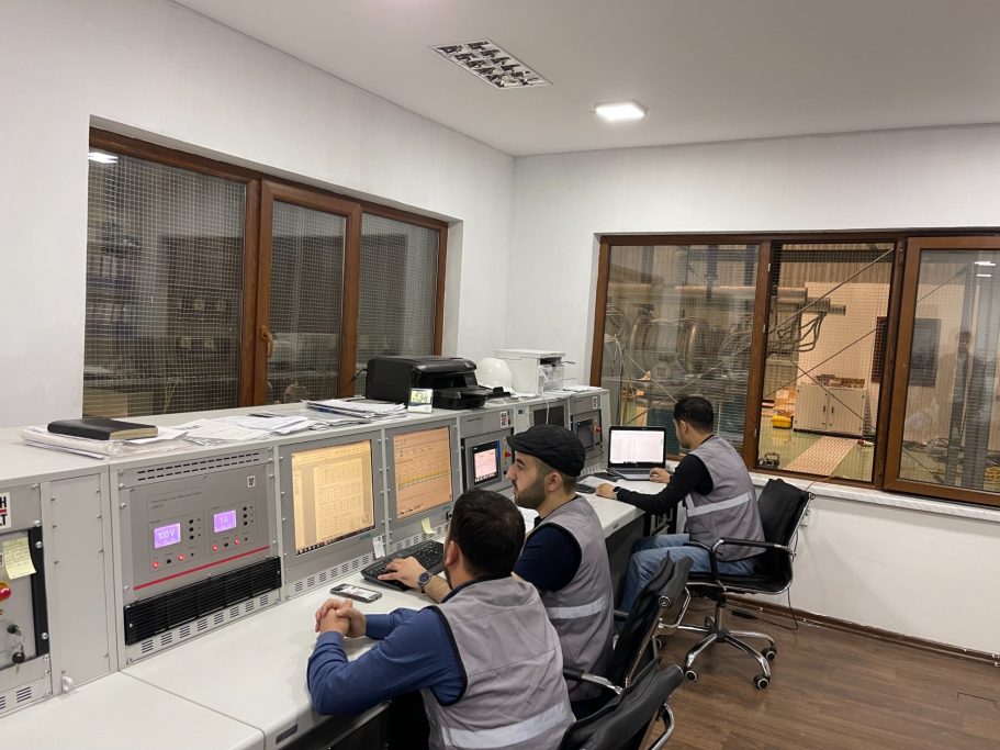Testing Facilities ATEF testing team operating equipment in a transformer testing control room